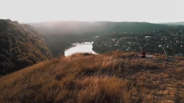 サンライズ山頂で瞑想する若いフィットネス女性 ドローン映像 — ストック動画