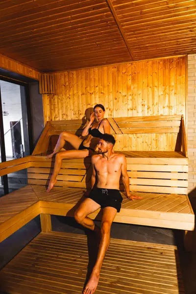 Shot of a young couple relaxing in a sauna.Hotel holiday concept