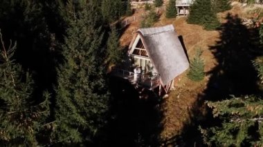 Birbirine aşık bir çift dağlardaki bir İskandinav evinin terasında poz veriyor. Düğün konsepti. 4k