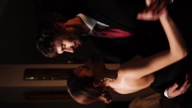 Birbirine aşık bir çift Noel gecesi bir restoranda dans eder. Noel kavramı. Dikey video.