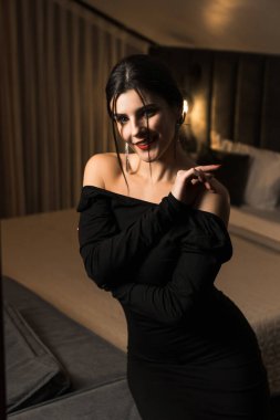 Siyah elbiseli, dairede poz veren zarif bir kadın. Moda çekim konsepti