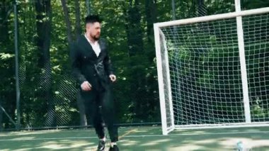 Klasik takım elbiseli bir grup arkadaş futbol oynarken eğleniyorlar. Futbol konsepti