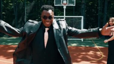 Klasik takım elbiseli bir grup arkadaş futbol oynarken eğleniyorlar. Futbol konsepti