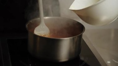 Şekerleme makinesi karamel hazırlamak için tavada şeker eritiyor. Evde karamel yapıyorum. Şekerleme ve kek kavramı