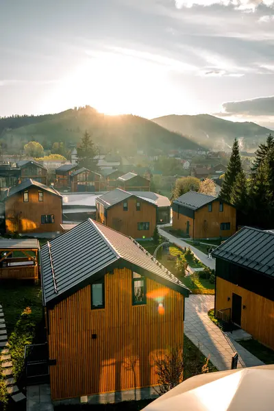 stock image Picturesque brown houses against the backdrop of snow-capped mountains. The concept of life in the mountains. Houses in the mountains