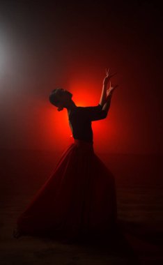 Kırmızı etekli bir kadının silueti neon ışıkta Latince dans ediyor. Dans konsepti. Bachata, Latino. Rumba. Samba.