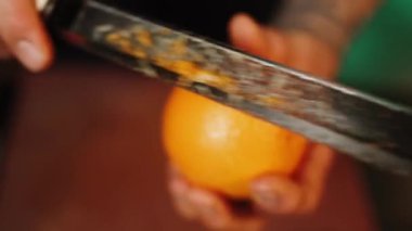 Bir şekerci limon, limon ve portakal kabuklarını rendeliyor. Turunçgil lezzeti üretimi. Şekerleme ürünleri kavramı