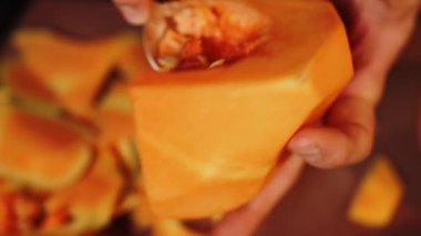 Aşçı olgun bir portakal kabağını keser. Balkabağı tabağı. Sonbahar yemekleri konsepti 4k