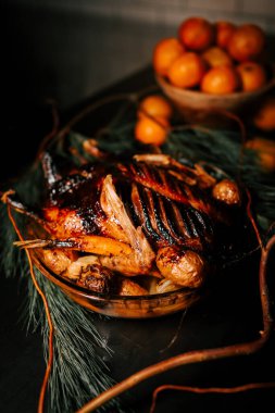 Roasted duck with sauce on a Christmas background. Baked meat in the oven. Christmas table concept. Low key clipart