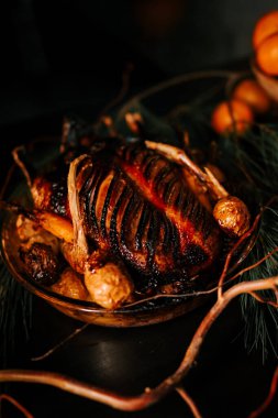 Roasted duck with sauce on a Christmas background. Baked meat in the oven. Christmas table concept. Low key clipart