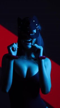Kedi Maskeli ve Kelepçeli Ateşli Kadın Büyüleyici bir BDSM Estetik Gösterisine Karşı Poz Veriyor