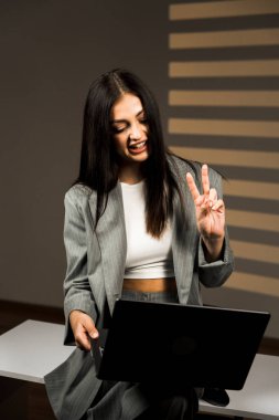 Young business woman working with laptop in modern office during daytime.Online work concept.Portrait of office worker.Woman with laptop clipart