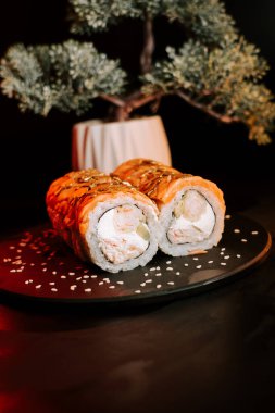 Zıt Renkler ve Dokularla Zarif Koyu Yüzeyde Taze Suşi Yuvarlamaları Gösterildi