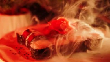 Suşi siyah arka planda döner. Lezzetli Japon suşisi hazır ve nazır. Taze unagi suşi ve somon ve Philadelphia peynirli rulo..