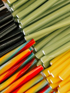 Colorful variety of licorice sticks arranged neatly on a table for a candy display