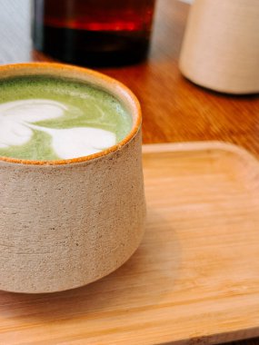 Huzurlu bir kafede eşsiz bir seramik bardakta servis edilen nefis bir kibrit içeceğinin tadını çıkarıyorum.