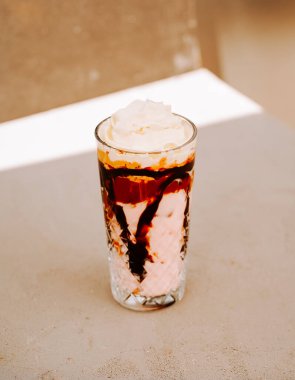 Kafenin arka planında bir bardakta servis edilen nefis tatlı içeceği.