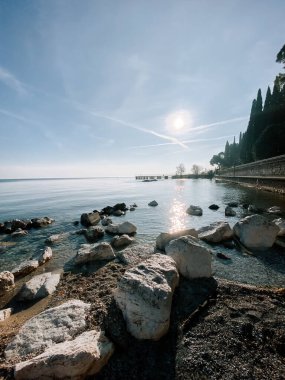 Güzelim göl manzarası berrak gökyüzü ve sabah ışığında kayalık kıyı.