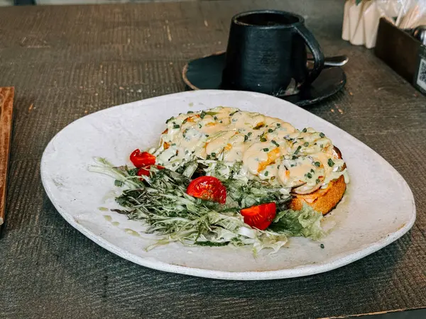 Sıcak bir kafe ortamında tabakta lezzetli bir yemeğin sunumu.