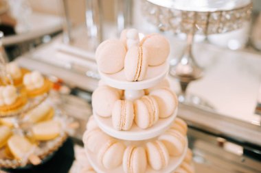 Kutlama sırasında tatlı masasının üstünde beyaz badem kurabiyelerinin zarif bir şekilde sergilenmesi.