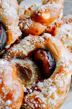 Sweet pastries filled with plum and topped with powdered sugar at a bakery