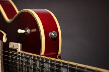 A semi acoustic electric guitar in red color