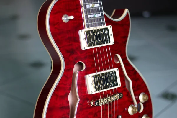 A semi acoustic electric guitar in red color