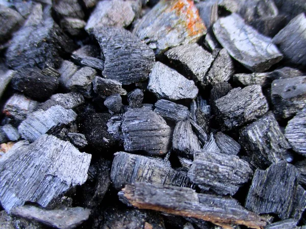 stock image charcoal is a lightweight black carbon reesidue produced by strongly heating wood. charcoal is widely used for cooking or other industries.