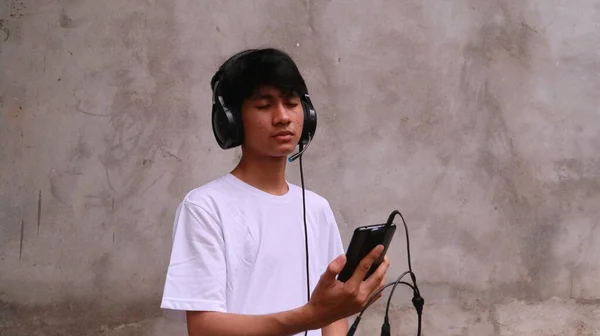 Asiático Hombre Está Utilizando Smartphone Auriculares Para Escuchar Canción — Foto de Stock
