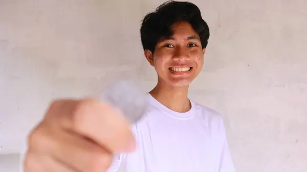 Een Aziatische Man Een Wit Shirt Houdt Toont Indonesische Munten — Stockfoto