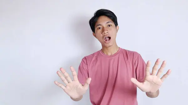 stock image Stop. Concerned Asian man showing refusal sign, saying no, raising awareness, standing over white background