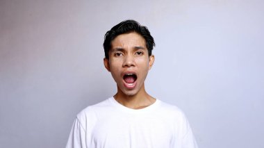 Beyaz tişört giyen Asyalı genç adamı kapat.