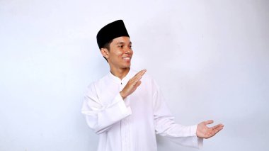 Yakışıklı Asyalı Müslüman genç adam gülümseyen promosyon pozu, ürün ve indirim. İzole edilmiş beyaz arkaplan önerisi