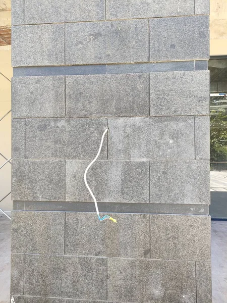 Electrical installation mounted on a natural stone wall.