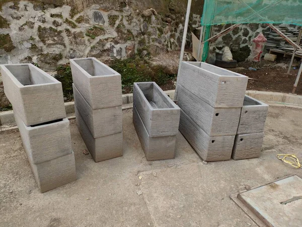 some planter boxes, made of molded concrete. ready to be installed in the garden or outdoor.