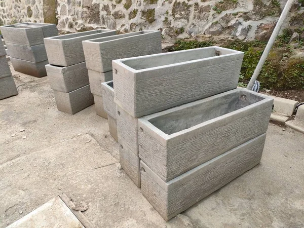 some planter boxes, made of molded concrete. ready to be installed in the garden or outdoor.