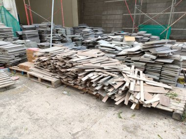 pile of natural stone tiles that have been cut to the size of the pattern. ready to install.