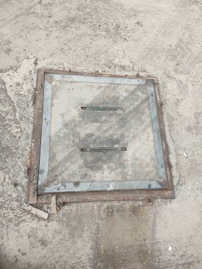 drainage maintenance holes, made of concrete and iron frames.