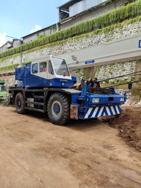 Close up mobile crane, in a building project area. Bali - Indonesia ; January 28, 2023.