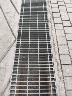 drain gutter with cast iron grill cover.