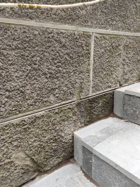 walls with a rough textured plaster finish, with a grout line pattern.