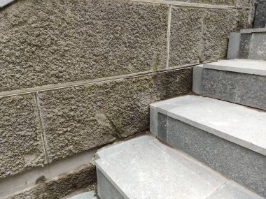 walls with a rough textured plaster finish, with a grout line pattern.