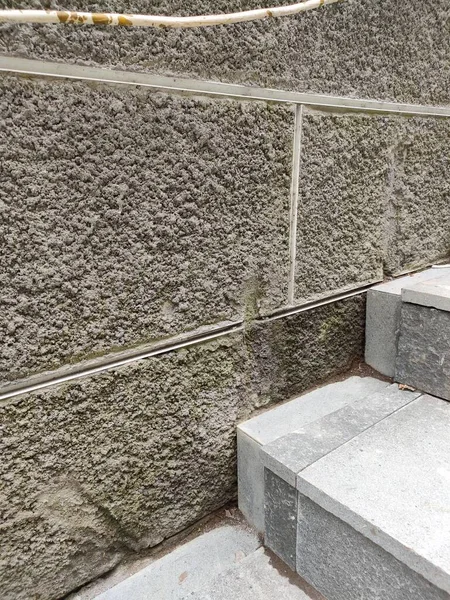 walls with a rough textured plaster finish, with a grout line pattern.