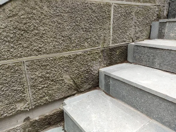 walls with a rough textured plaster finish, with a grout line pattern.