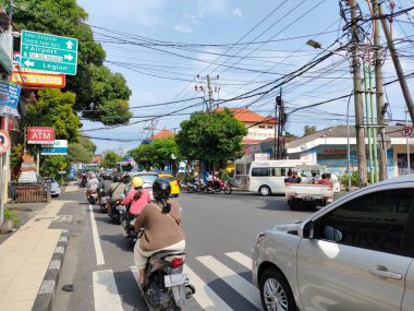 normal and smooth traffic at the intersection of Jalan Raya Kuta. Bali - Indonesia ; January 3, 2023.