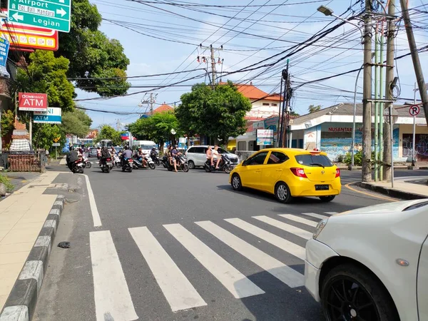 normal and smooth traffic at the intersection of Jalan Raya Kuta. Bali - Indonesia ; January 3, 2023.