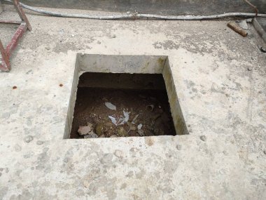 maintenance hole to clean garbage and sludge in the drainage. not yet closed.
