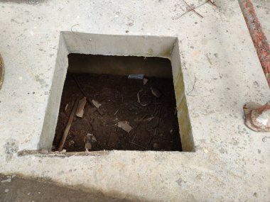 maintenance hole to clean garbage and sludge in the drainage. not yet closed.