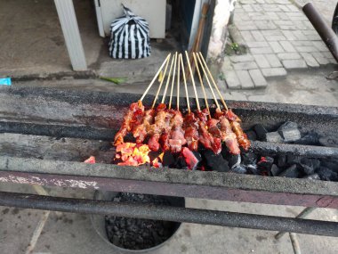 close up of satay being grilled. good food.