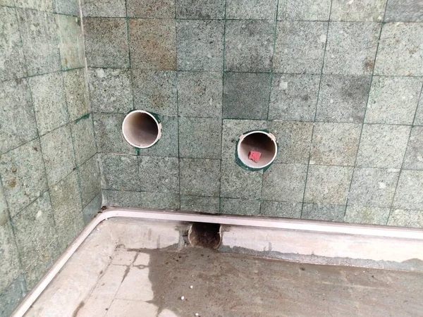installation of pipes on the walls of ornamental ponds for water circulation and drain.